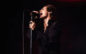 The Iconic Harry Styles In A Captivating Black And White Portrait. Wallpaper