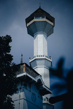 The Majestic Clock Tower Of Bandung Mosque In Sunset Wallpaper