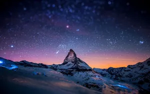 The Matterhorn At Night With Stars Above It Wallpaper