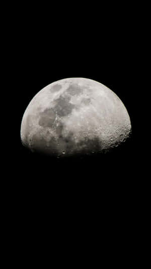The Moon Is Seen In The Dark Sky Wallpaper