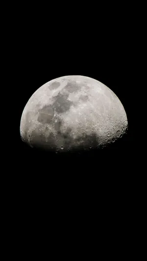The Moon Is Seen In The Dark Sky Wallpaper
