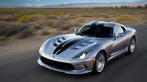 The Powerful And Intense Dodge Viper Thrilling On Roadway Wallpaper
