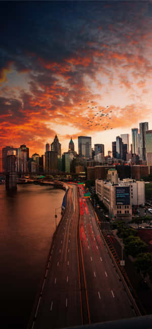 The Sun Sets Beyond The Modern City Skyline. Wallpaper