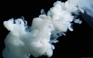 Thick, Dark Smoke Swirls Against A Striking Black Background. Wallpaper