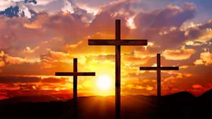Three Crosses In The Background With A Sunset Wallpaper