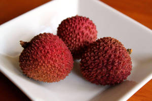 Three Litchis On Plate Wallpaper