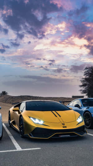 Three Sports Cars Parked In A Parking Lot Wallpaper