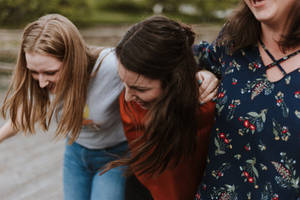 Three Teenage Girls Laughing Wallpaper