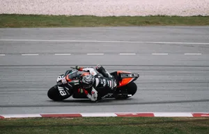 Thrilling Cornering Action By A Bike Rider Wallpaper