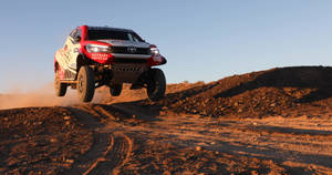 Thrilling Performance By Team Hilux At The Dakar Rally Wallpaper