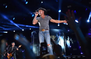 Tim Mcgraw Performing On Stage Wallpaper