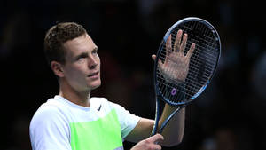 Tomas Berdych Inspecting Tennis Racket Wallpaper