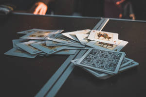 Tossed Cards On Table After Cheat Game Wallpaper