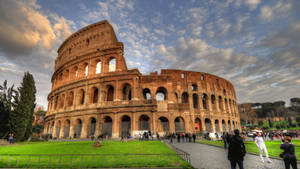 Tourists Taking Pictures Outside The Colosseum Wallpaper