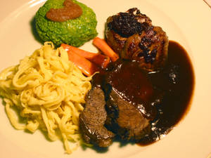 Traditional Sauerbraten Dish Served With Pasta And Mashed Vegetables Wallpaper