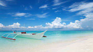 Tranquil Getaway - Boat Resting On A Pristine White Beach Wallpaper
