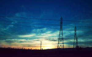 Transmission Towers With Current Sunrise View Wallpaper