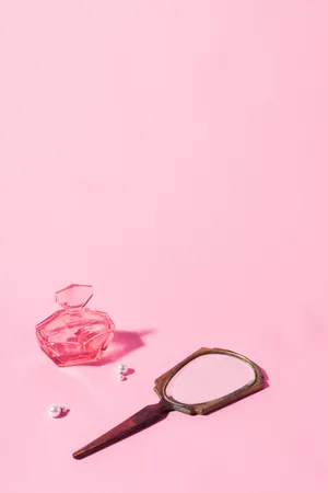Trinkets On Pastel Pink Color Table Wallpaper