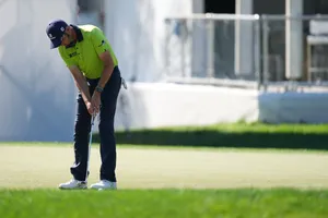 Troy Merritt Bending Down Aiming Ball Wallpaper