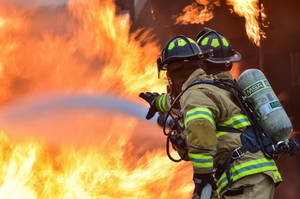 Two Firefighters Responding To A Fire Wallpaper