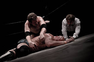 Two Men Fighting It Out In The Wrestling Ring Wallpaper