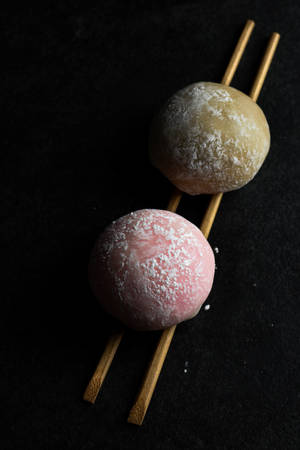 Two Mochi Pieces On Chopsticks Wallpaper