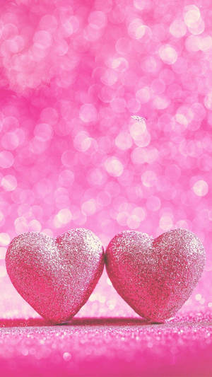 Two Pink Hearts Sparkle Wallpaper