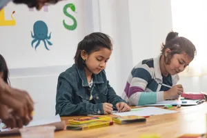 Two Young Girls Learning Wallpaper
