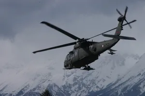 Uh 60 Black Hawk Helicopter Against Icy Mountain Wallpaper