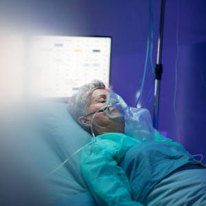 Unconscious Woman Receiving Medical Treatment In The Hospital Wallpaper