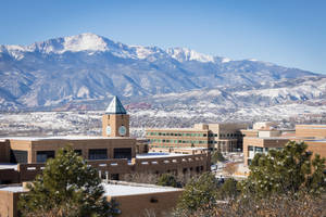 University Of Colorado Beautiful Campus Amid Snowy Mountains Wallpaper