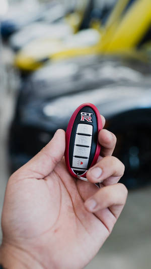 Unveiling The Excitement With A Close-up Of The Ravishing Nissan Gt-r Key Wallpaper