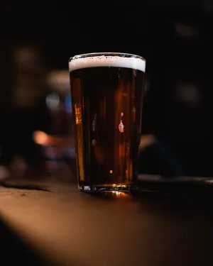 Unwind With A Glass Of Black Beer Wallpaper