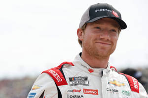 Up-close Look At Nascar Driver Tyler Reddick Flashing A Cheeky Smile Wallpaper