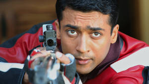 Vaaranam Aayiram Surya Aiming A Gun Wallpaper