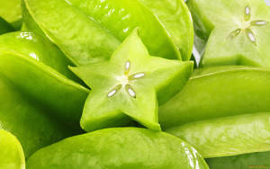 Vibrant Slice Of Green Star Fruit Wallpaper