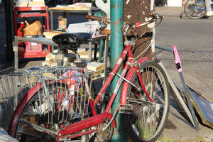 Vibrant Urban Red Bike On A Paved Street Wallpaper