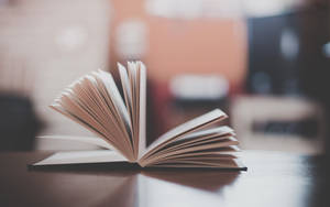 View Of An Open Book And Its Many Pages. Wallpaper