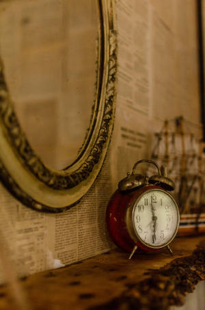 Vintage Clock Beside Mirror Wallpaper