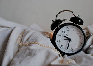 Vintage Clock On Bed Wallpaper