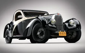 Vintage Grand Tourer: Witness The Timeless Charm Wallpaper