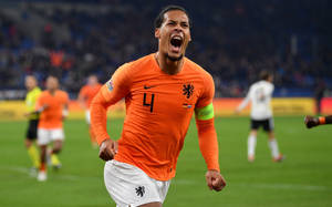 Virgil Van Dijk In Orange Jersey Wallpaper