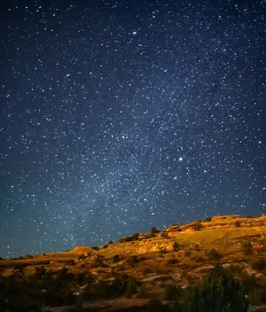 Visible Stars Over Mountainside Wallpaper