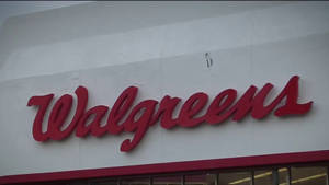 Walgreens Logo On White Concrete Wall Wallpaper