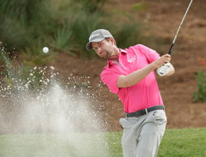 Webb Simpson Striking A Golf Ball From Sand Bunker Wallpaper