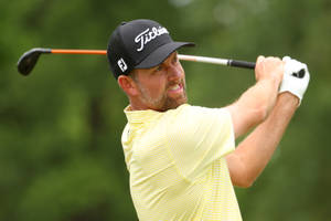 Webb Simpson Swinging A Silver And Orange Golf Club Wallpaper