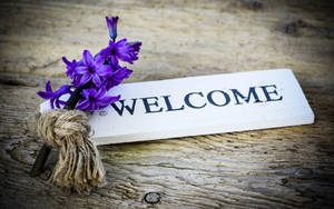 Welcome Decor With Purple Flowers Wallpaper