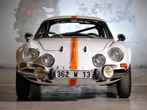 White Alpine Car With Orange Stripe Wallpaper