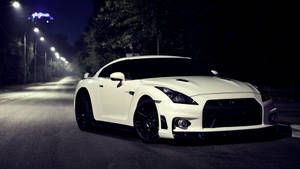 White Nissan Gtr Car On A Dark Road Wallpaper