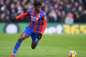 Wilfried Zaha Running After Football Wallpaper